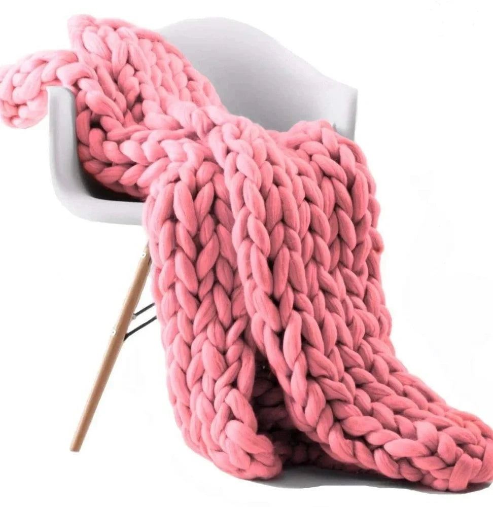 Hand woven wool blanket with soft chenille texture in navy blue colour draped over sofa