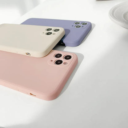Simple solid colour silicone iPhone case in blue, pink, and white showing TPU back cover design.