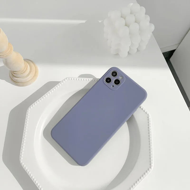 Simple solid colour silicone iPhone case in blue, pink, and white showing TPU back cover design.