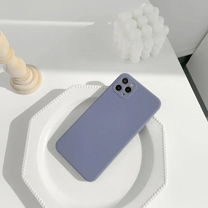 Simple solid colour silicone iPhone case in blue, pink, and white showing TPU back cover design.