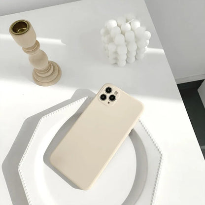 Simple solid colour silicone iPhone case in blue, pink, and white showing TPU back cover design.