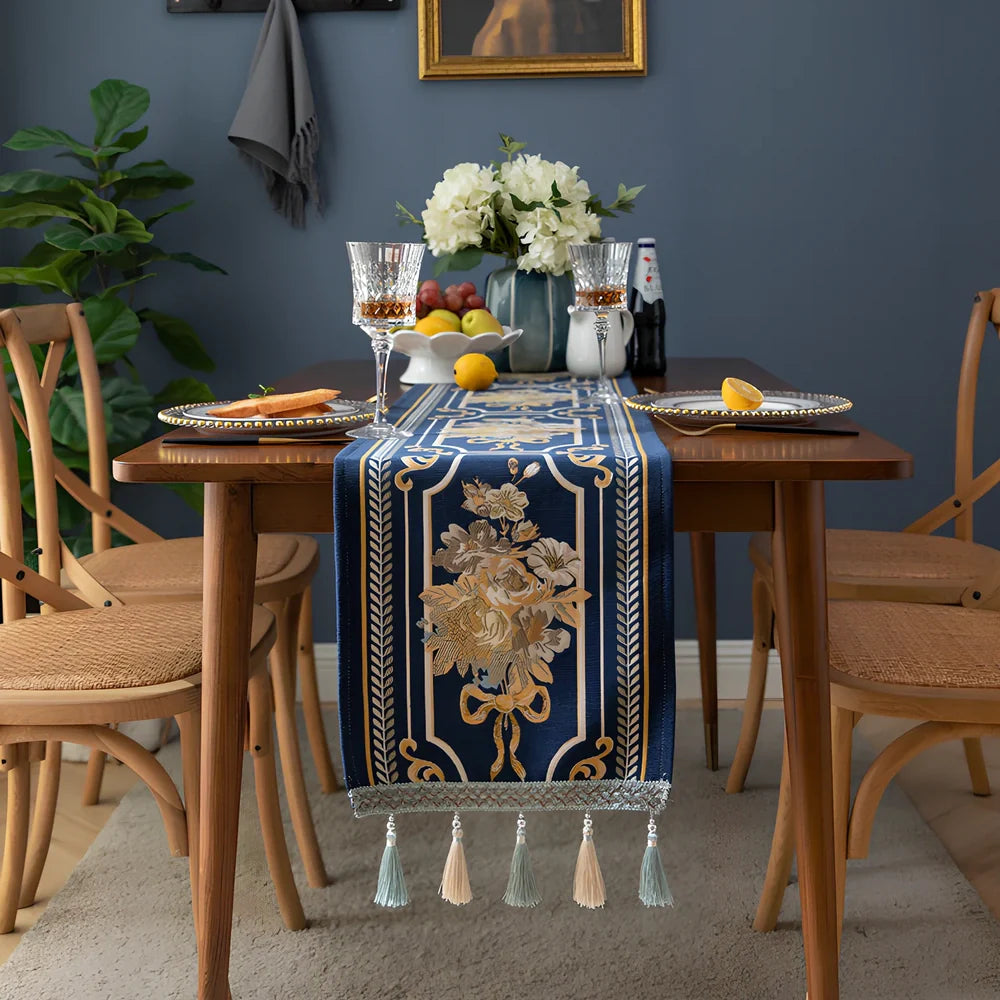 White chenille table runner with long tassels on wooden dining table