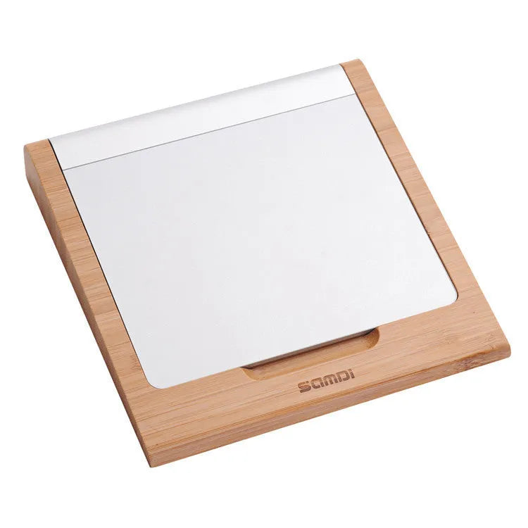 Bamboo wood stand holding an Apple tablet and an Apple Bluetooth trackpad side by side.