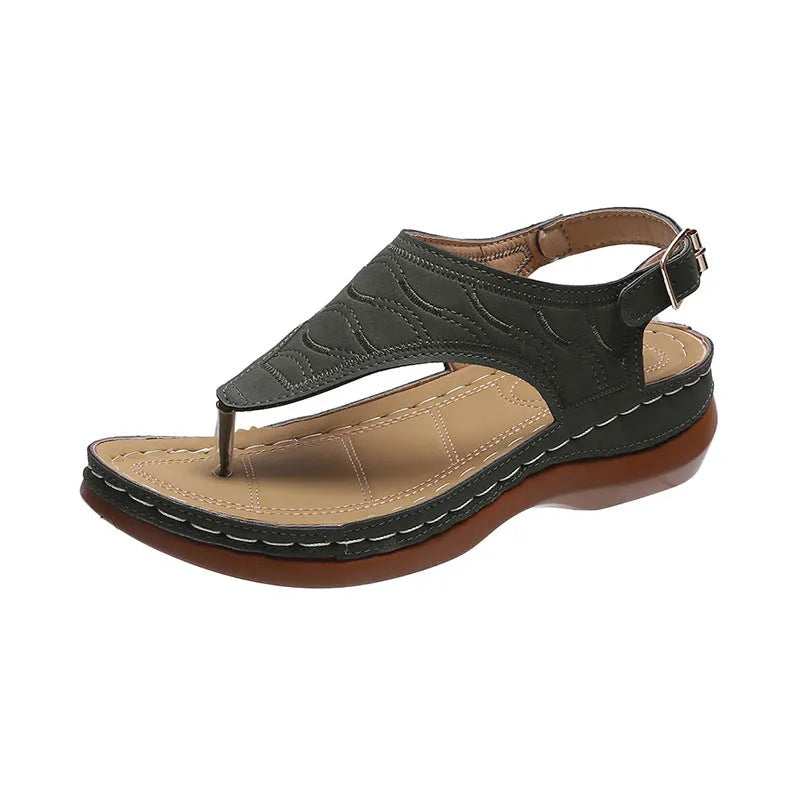 Women's wedge heel flip flop sandals in black with adjustable back strap on a light background