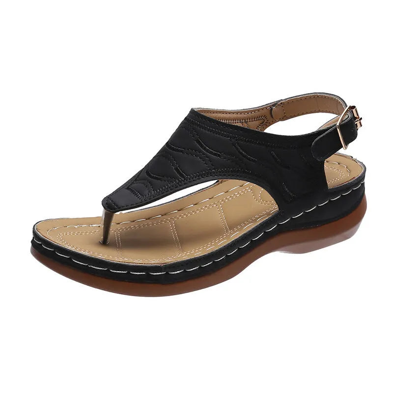 Women's wedge heel flip flop sandals in black with adjustable back strap on a light background