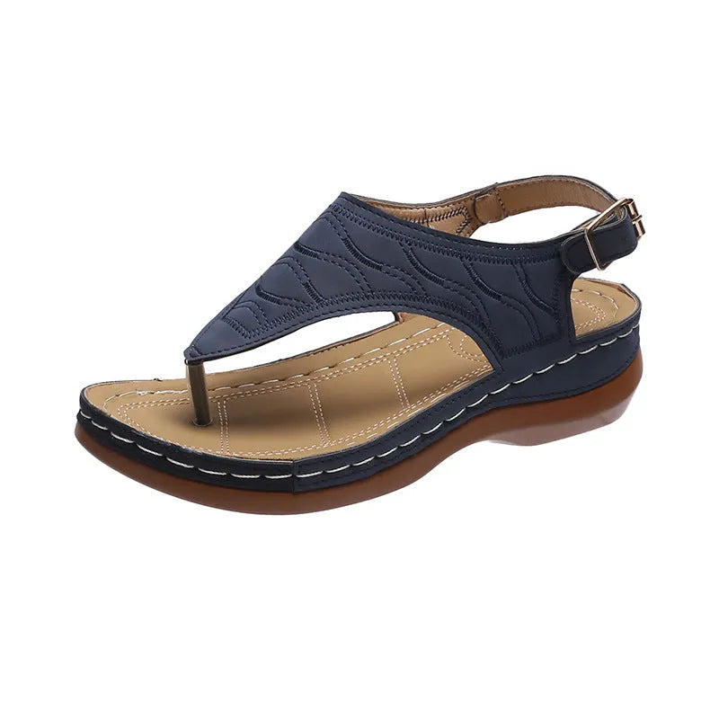 Women's wedge heel flip flop sandals in black with adjustable back strap on a light background