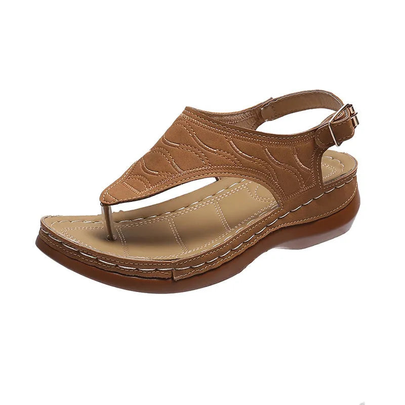 Women's wedge heel flip flop sandals in black with adjustable back strap on a light background