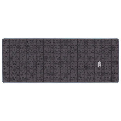 Grey cloth wrist sticker for computer mouse on a desk, showing non-slip base.