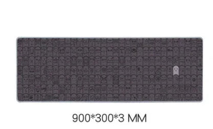 Grey cloth wrist sticker for computer mouse on a desk, showing non-slip base.