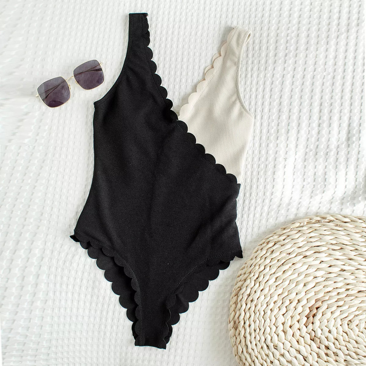 Women's black and white one-piece swimsuit with unique petal edge stitching