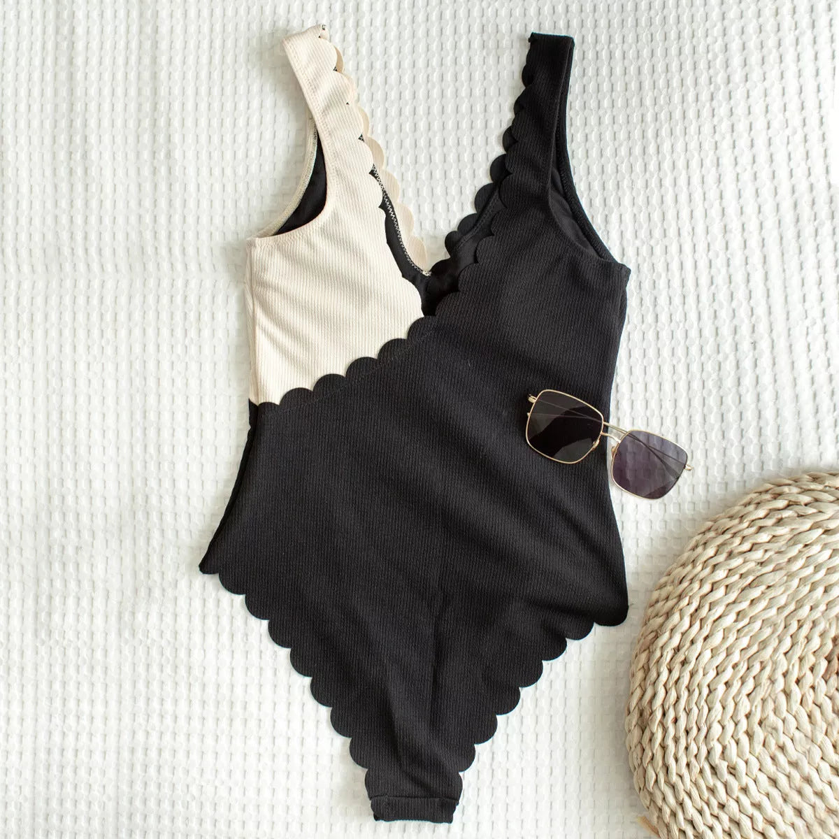 Women's black and white one-piece swimsuit with unique petal edge stitching
