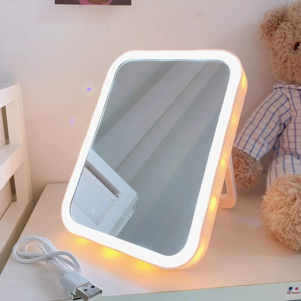 Japanese LED desktop vanity mirror folded showing white plastic frame and USB power port