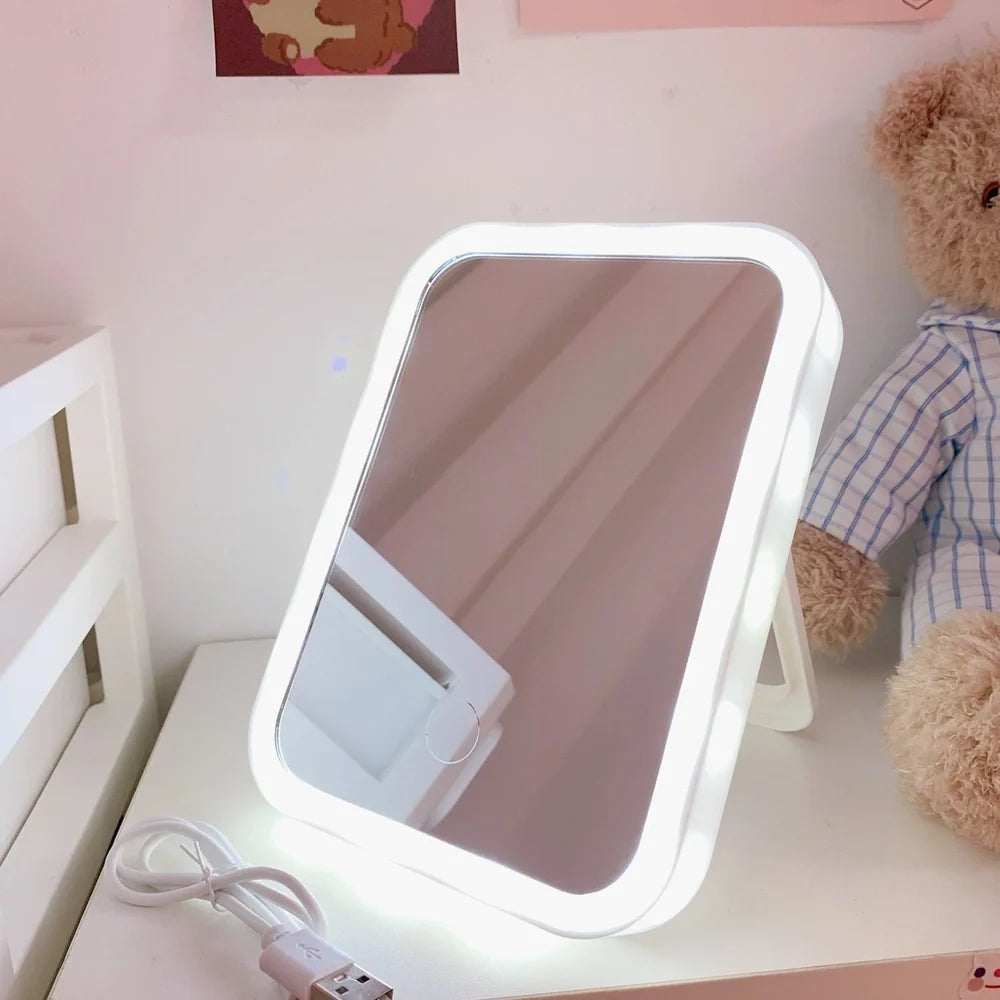 Japanese LED desktop vanity mirror folded showing white plastic frame and USB power port