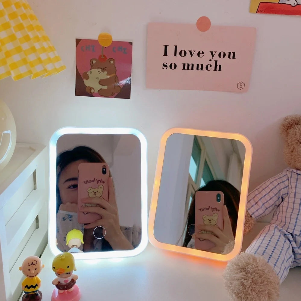 Japanese LED desktop vanity mirror folded showing white plastic frame and USB power port