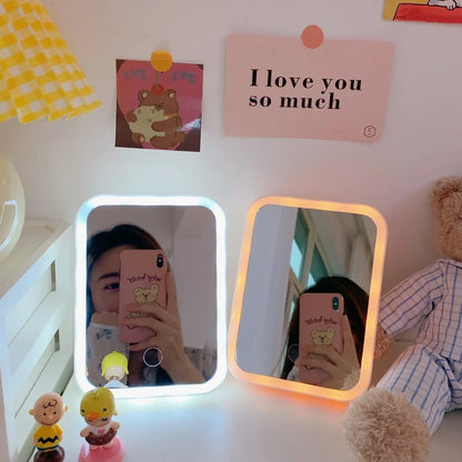 Japanese LED desktop vanity mirror folded showing white plastic frame and USB power port