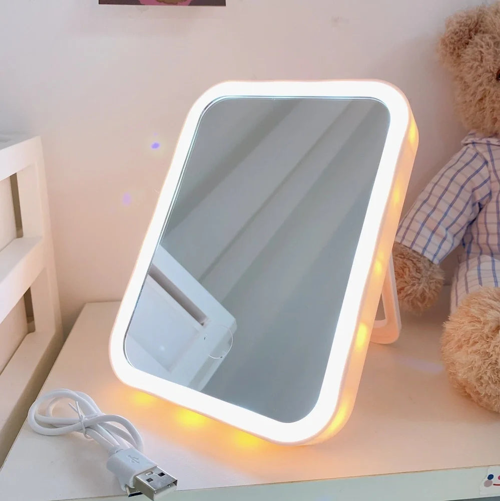 Japanese LED desktop vanity mirror folded showing white plastic frame and USB power port