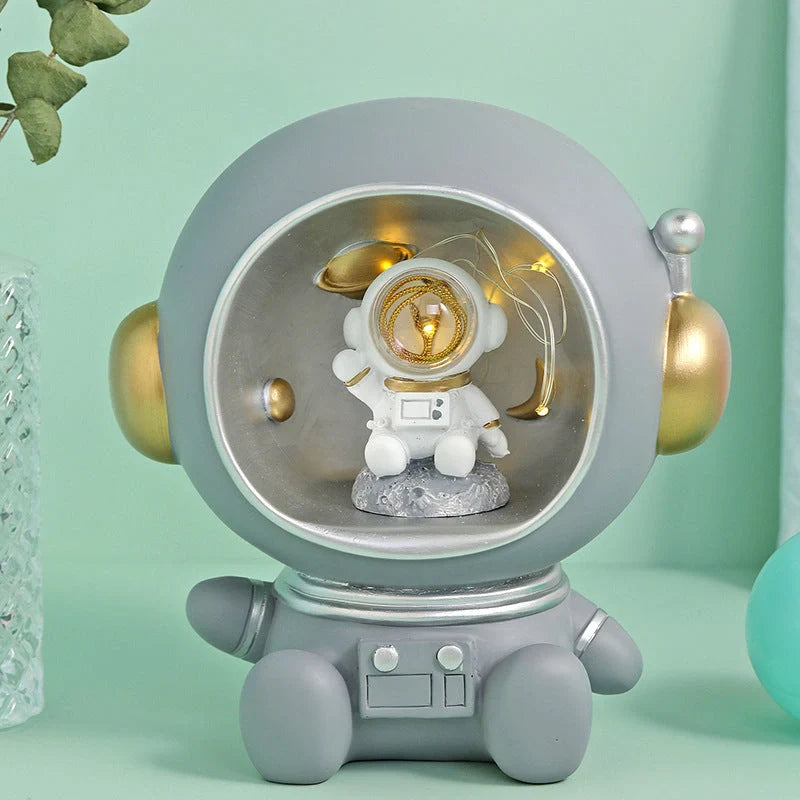 Astronaut-themed resin piggy bank with LED night light feature