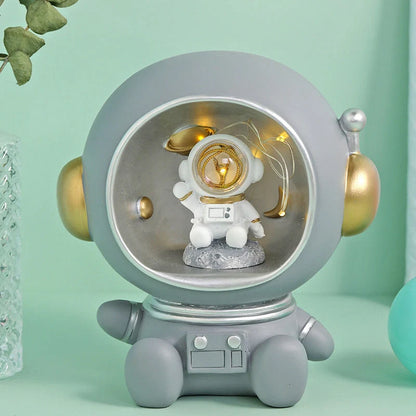 Astronaut-themed resin piggy bank with LED night light feature