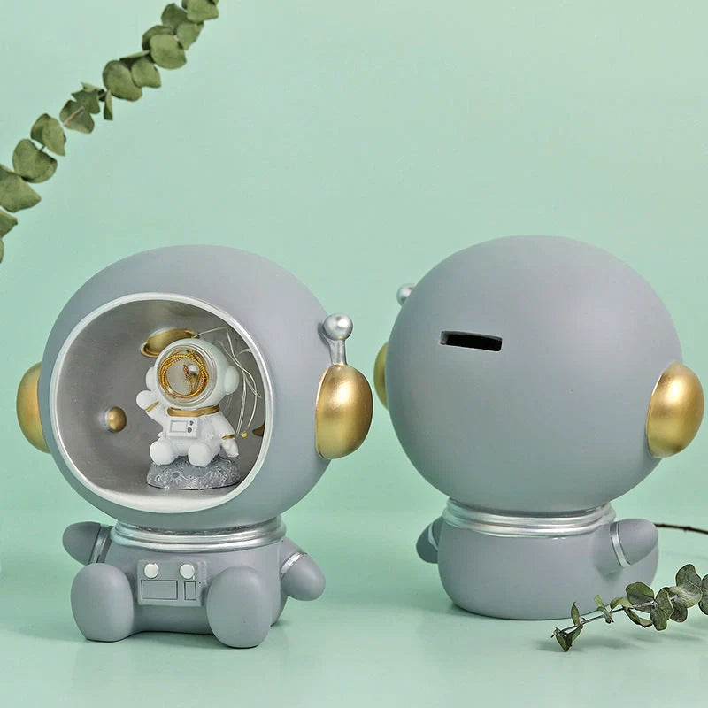 Astronaut-themed resin piggy bank with LED night light feature