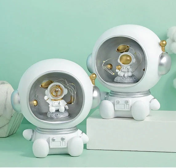 Astronaut-themed resin piggy bank with LED night light feature