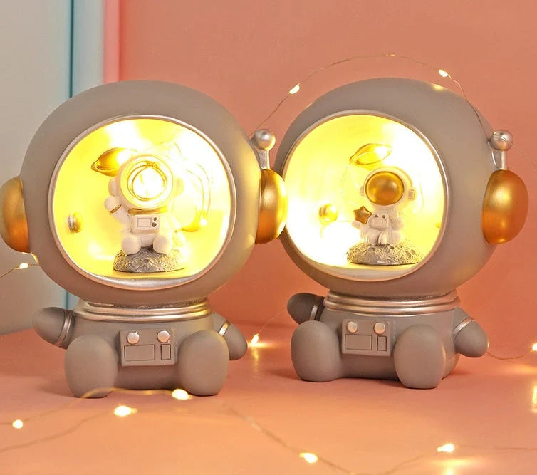 Astronaut-themed resin piggy bank with LED night light feature