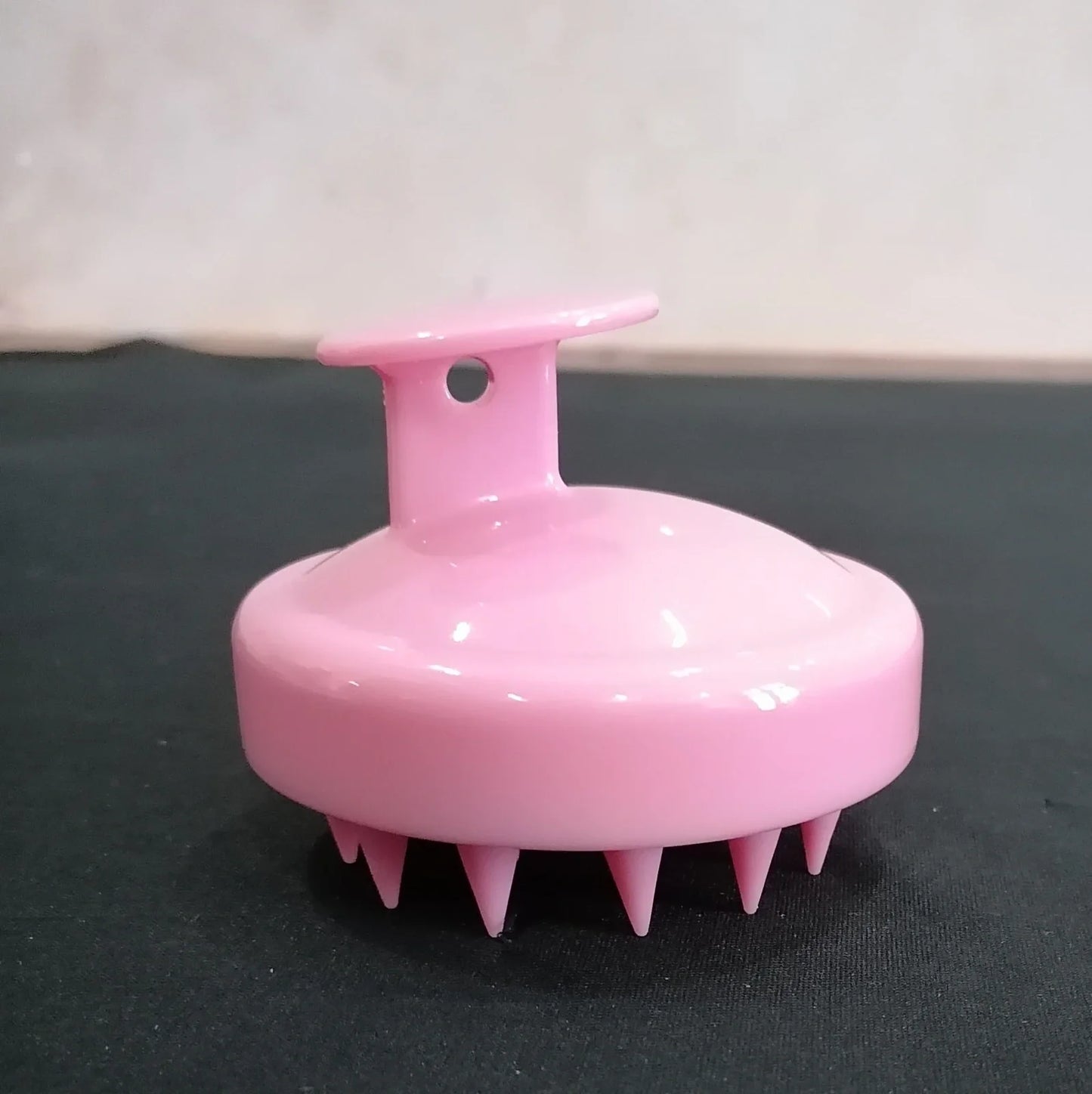 Black silicone shampoo brush with hook design measuring 8x8x7cm for scalp massage during hair washing