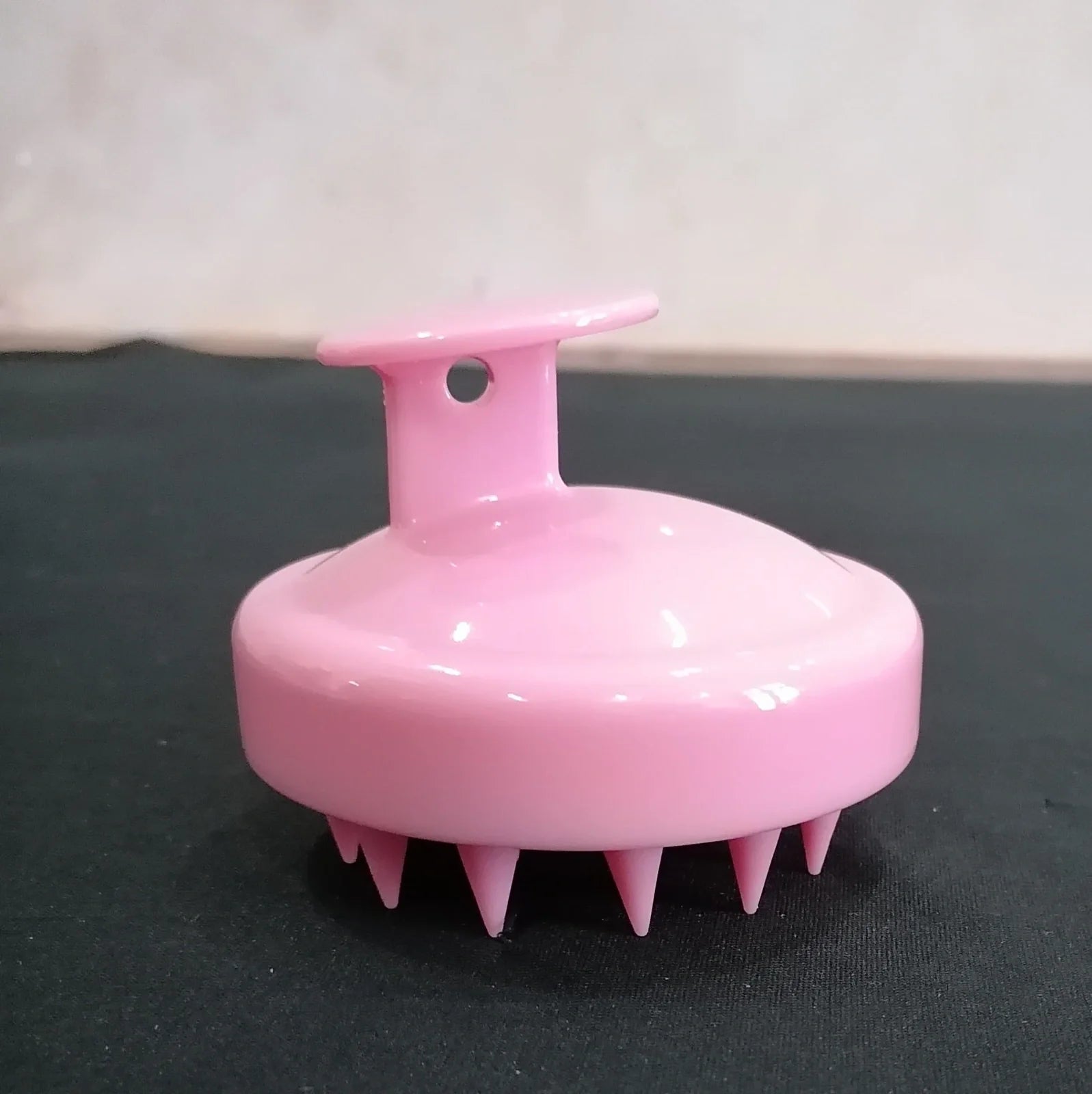 Black silicone shampoo brush with hook design measuring 8x8x7cm for scalp massage during hair washing