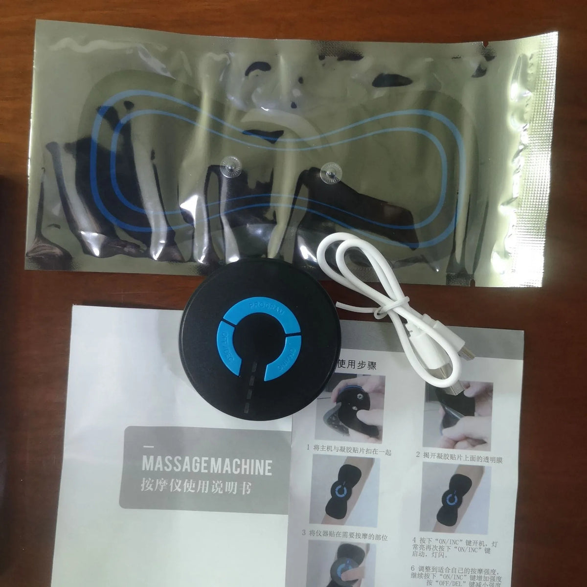 Black HQ-185 mini electric shoulder and neck massager with massage patch, showing compact 15cm size.
