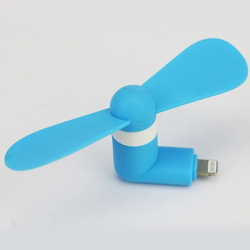 White portable mobile phone mini fan with plastic blades attached to smartphone