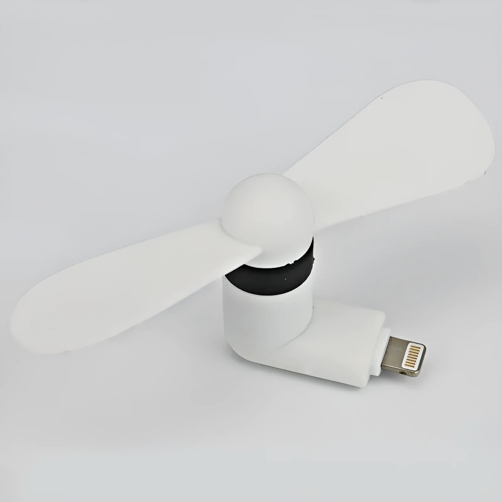 White portable mobile phone mini fan with plastic blades attached to smartphone
