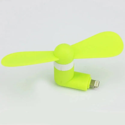White portable mobile phone mini fan with plastic blades attached to smartphone