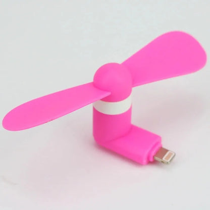 White portable mobile phone mini fan with plastic blades attached to smartphone