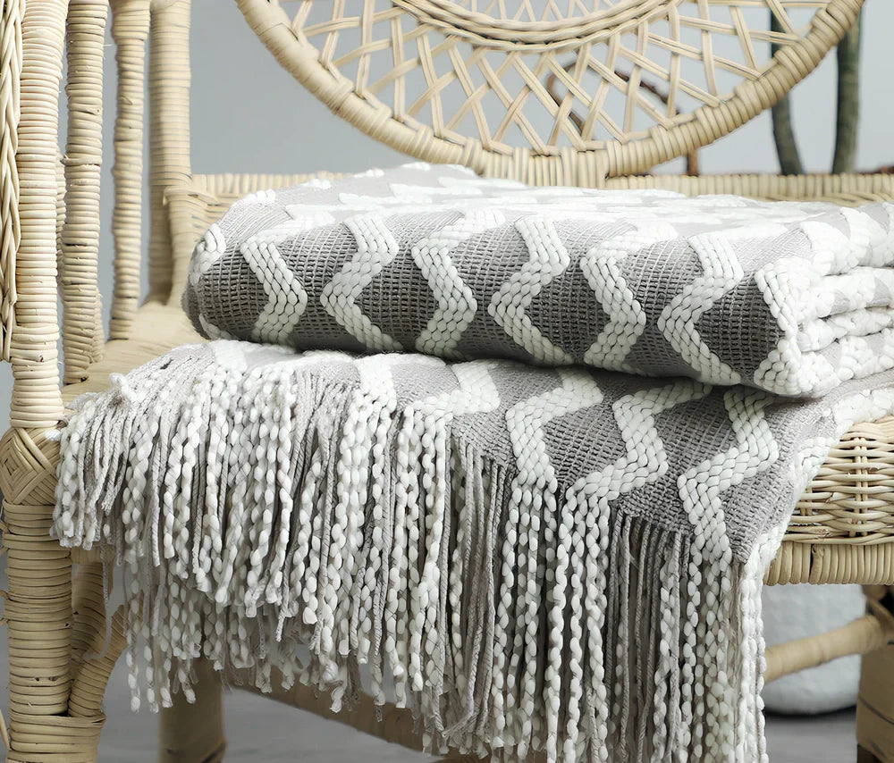 Nordic knitted decorative blanket with striped pattern and tassels in light grey colour