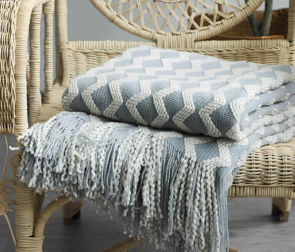Nordic knitted decorative blanket with striped pattern and tassels in light grey colour