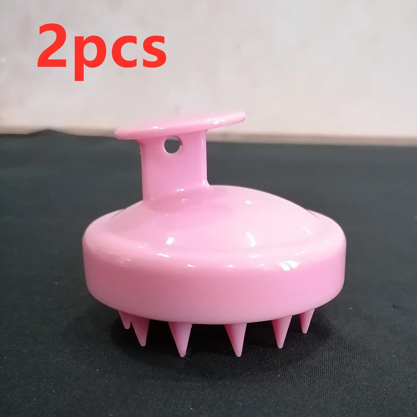 Black silicone shampoo brush with hook design measuring 8x8x7cm for scalp massage during hair washing