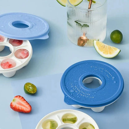Donut-shaped ice cube molds in orange and blue, perfect for creative drink presentation.