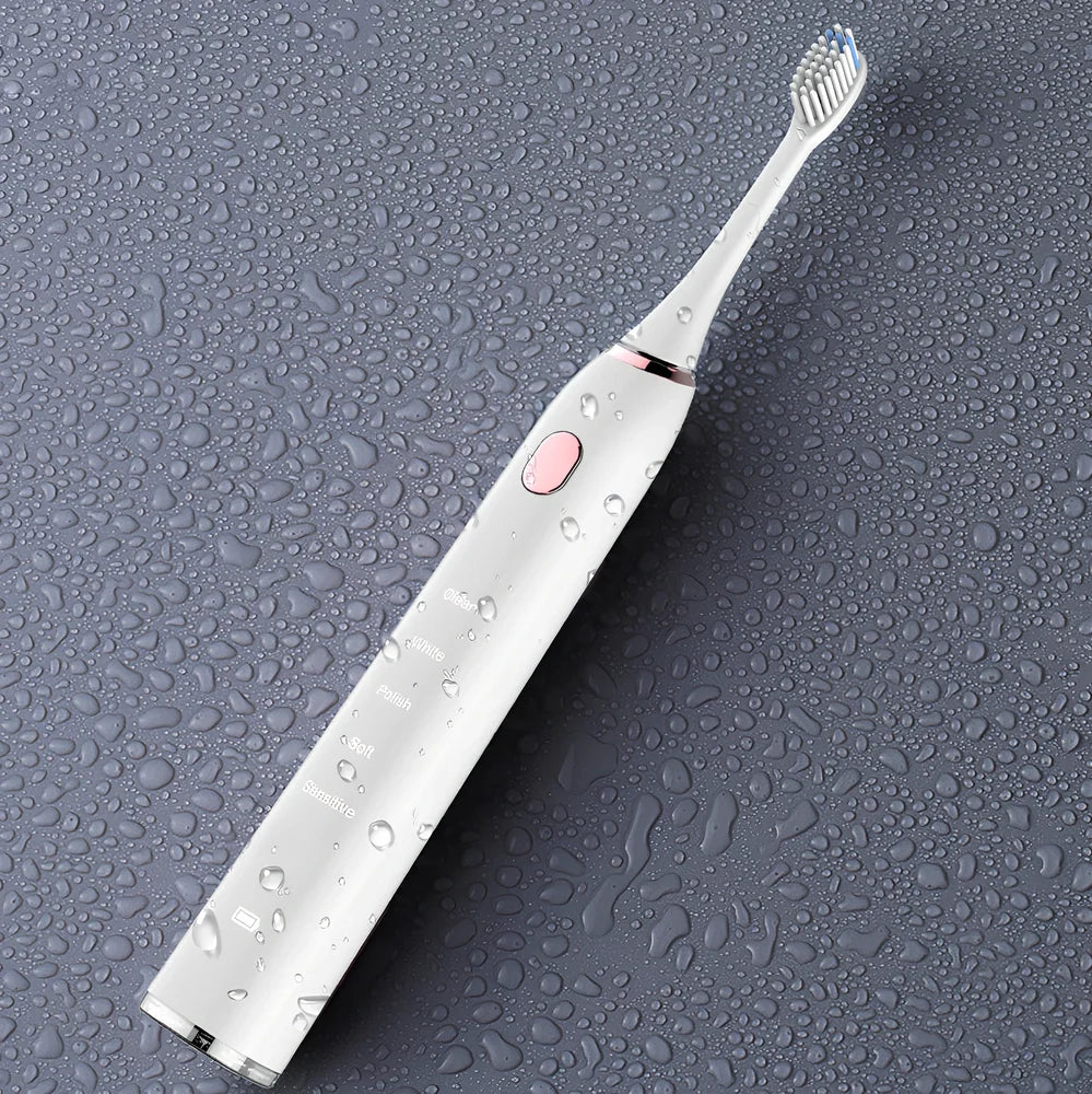 White waterproof electric toothbrush with inductive charging base showing 5 cleaning modes