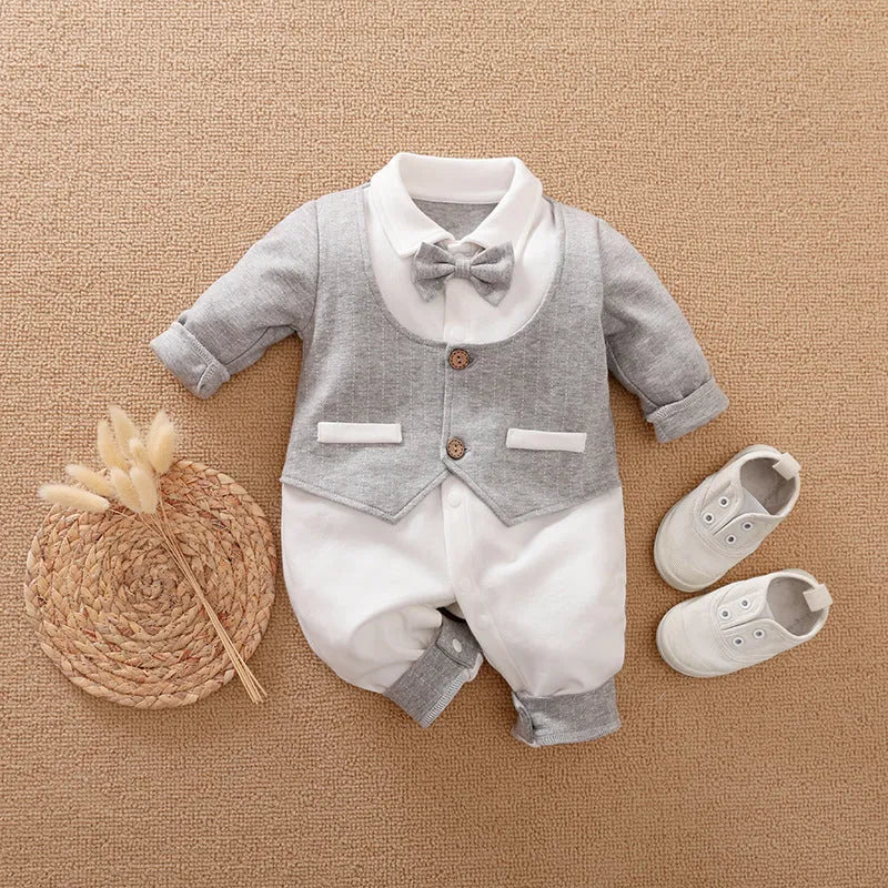 Baby boy in a long-sleeved cotton jumpsuit, gentleman style with collar, in navy blue colour.