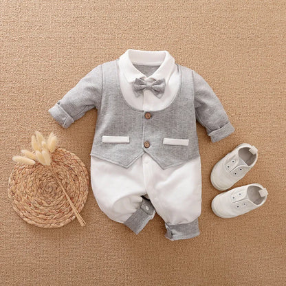 Baby boy in a long-sleeved cotton jumpsuit, gentleman style with collar, in navy blue colour.
