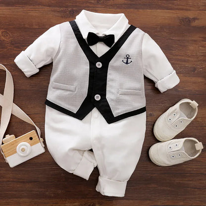 Baby boy in a long-sleeved cotton jumpsuit, gentleman style with collar, in navy blue colour.