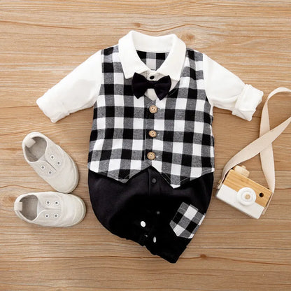 Baby boy in a long-sleeved cotton jumpsuit, gentleman style with collar, in navy blue colour.