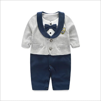 Baby boy in a long-sleeved cotton jumpsuit, gentleman style with collar, in navy blue colour.