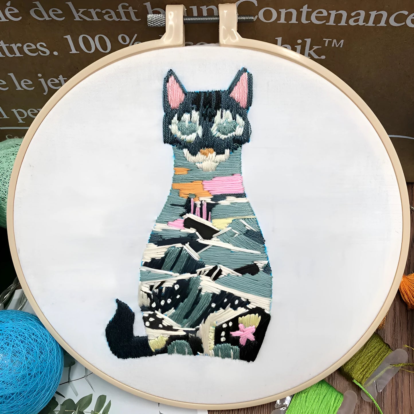 Beginners DIY embroidery kit showing materials for a three-dimensional cat cross stitch design on 20cm cotton linen fabric.