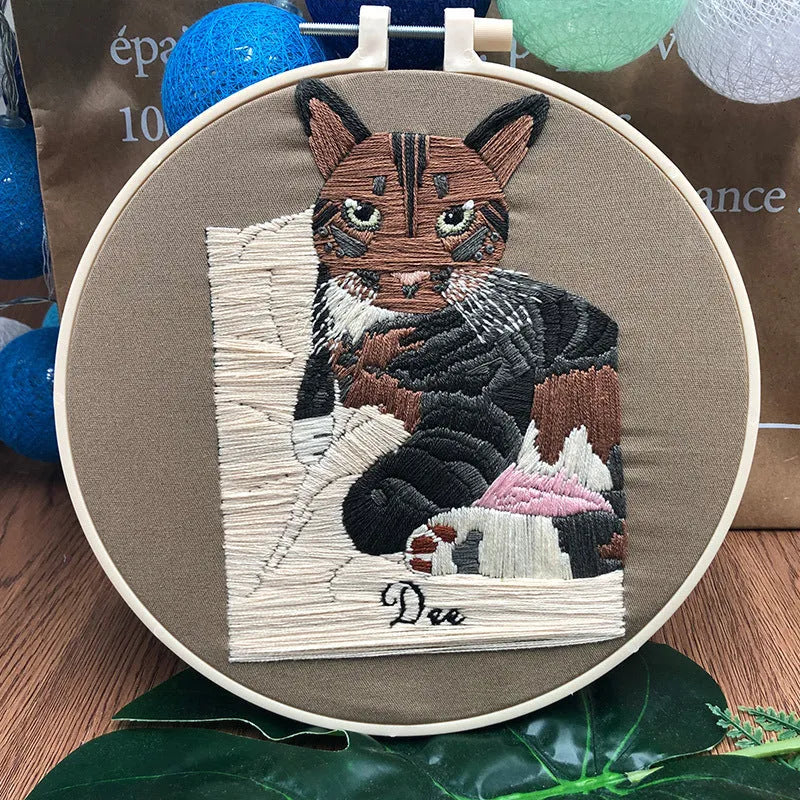 Beginners DIY embroidery kit showing materials for a three-dimensional cat cross stitch design on 20cm cotton linen fabric.