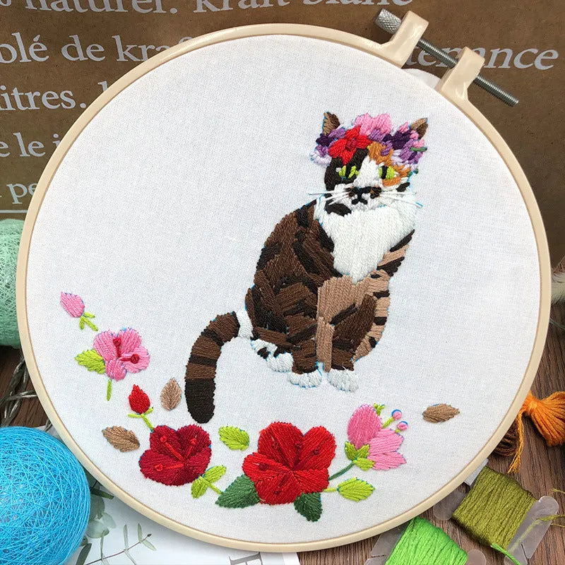 Beginners DIY embroidery kit showing materials for a three-dimensional cat cross stitch design on 20cm cotton linen fabric.
