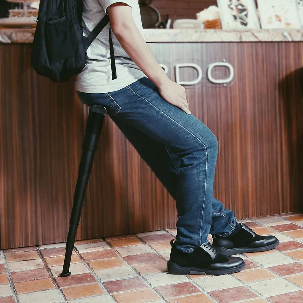 Compact folding outdoor camping stool in black, featuring a telescopic design for easy storage and portability