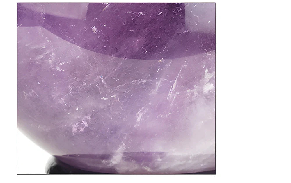 Natural purple amethyst crystal ball with polished surface in geometric sphere form