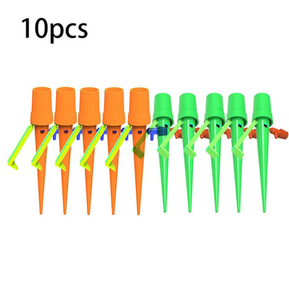 Set of green and orange plastic watering spikes, 16.5 cm tall, for garden plant hydration