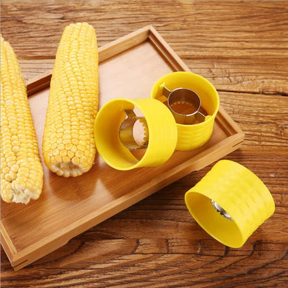 Yellow manual corn grinder thresher with corn-shaped design and stainless steel gear for peeling corn kernels.