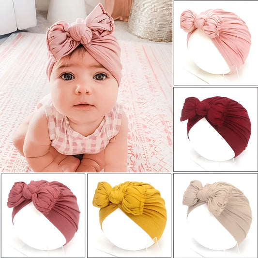Soft acrylic knitted baby cap for newborns and toddlers in a solid colour, showing stretch fit.
